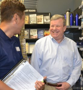Director/CEO Tom Shull shares a smile with an associate at Osan’s Military Clothing Store during his recent visit.