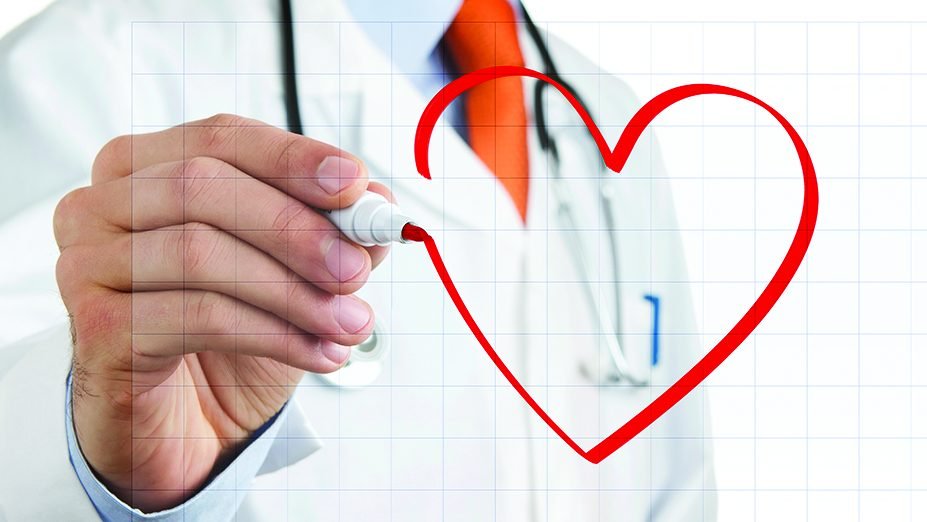 Male doctor drawing heart symbol at the whiteboard Male doctor drawing heart symbol at the whiteboard