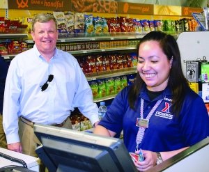 Associate Charmaine Dagatan at Coalition Compound Tent store rings up Tom Shull, who bought a bottle of water with his MILITARY STAR card.