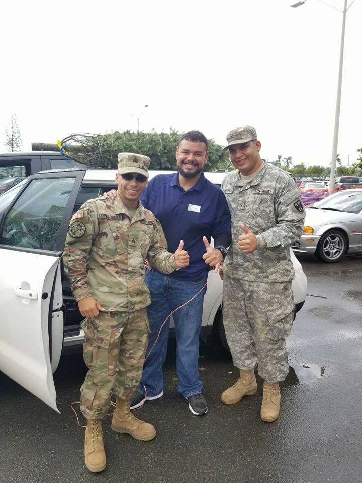FtBuchananTrees Customers receive help for an associate as they tie the tree on their car.