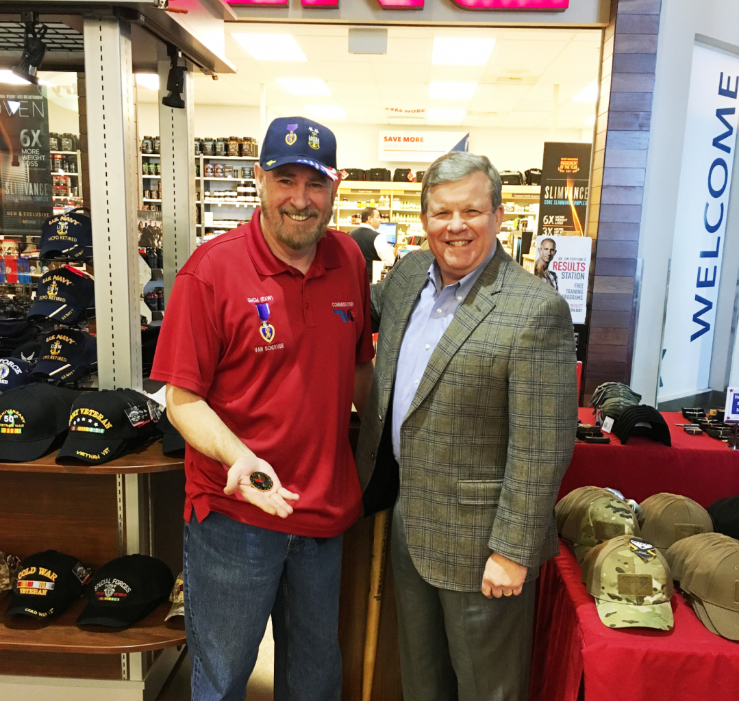Tinker feature Retired Navy Master Chief Petty Officer Larry Van Schuyver receives a coin from Director/CEO Tom Shull during a recent visit.