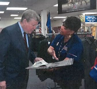 fortcarson Associate Marta Antonio shows Exchange Director/CEO Tom Shull her scrapbook.