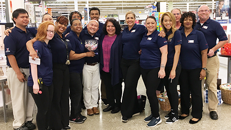 Group_Ms.Middleton1 President and Chief Merchandising Officer Ana Middleton, center, stands with Fort Meade associates, who received her coins for getting glowing customer comments.