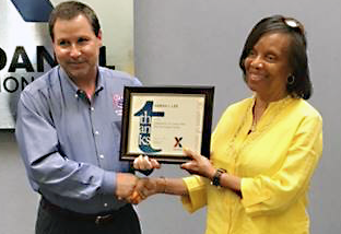 Sarah Lee Dan Daniel DC manager Sarah Lee receives her 30-year service award from Alan French, vice president of the Logistics Directorate. French's dad hired Lee to work at the DC.