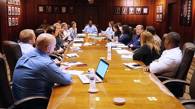 Hurricane Exchange Director/CEO Tom Shull, center, right, and senior managers talk about how to best serve Warfighters and their families caught in Hurricane Florence.