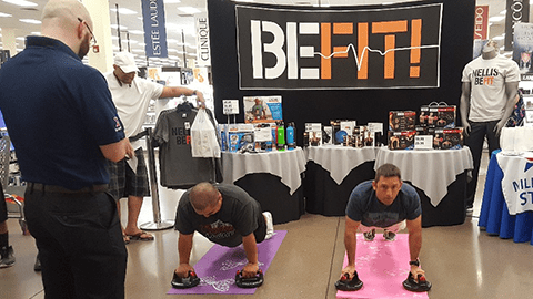 NELLIS NELLIS AFB, Nev - Associate Paul Ackerly officiates the perfect pushup contest during a “Healthy Lifestyle” event that featured the Exchange's Be Fit products.