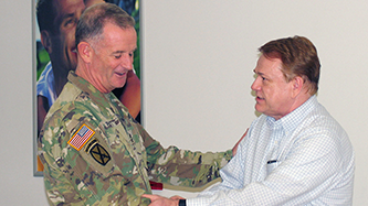 IMG_3125 Fort Drum General Manager James Osborne, right, shakes hands with Division Commander Maj. Gen. Walter Piatt. The commander stopped by the Exchange to thank Osborne for his service to the Soldiers.