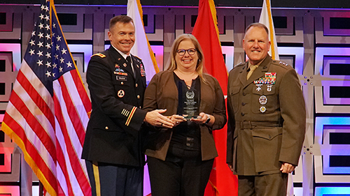 image001 Col. Douglas Vallejo, deputy director, Logistics; and Morgan Meeks, vice president, Transportation Operations, accept the award from TRANSCOM Deputy Commander Marine Corps Lt. Gen. John Broadmeadow, right.