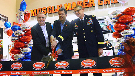 Ribboncutting Fort Sill Exchange general manager Don Walter Jr.; Mike Roper, Muscle Maker Grill CEO; and Maj. Gen. Wilson A. Shoffner, Fort Sill commanding general, cut the ribbon to open Muscle Maker Grill Nov. 21.