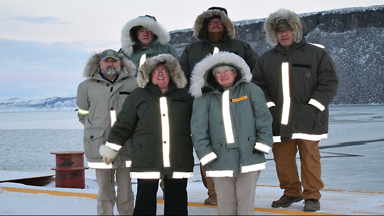 Thule Frank Partridge, Thule store manager; Timothy Barba, shift manager; Osa Fatuesi, assistant store manager; Bill Miele, shift manager; Deborah Mills, barber; and Phyllis Blackburn, store manager, are serving at the Thule Exchange in Greenland.