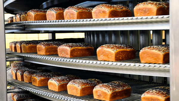 Bakery Loaves of bread on rotating shelf in Exchange bakery.