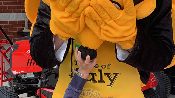 Fort Lee Safety Bee FORT LEE, Va. - A little girl squeezes the nose of the Exchange safety bee mascot during the grand opening of the store's outdoor living center. Playing the mascot was Loss Prevention's Cooper Stegmann.