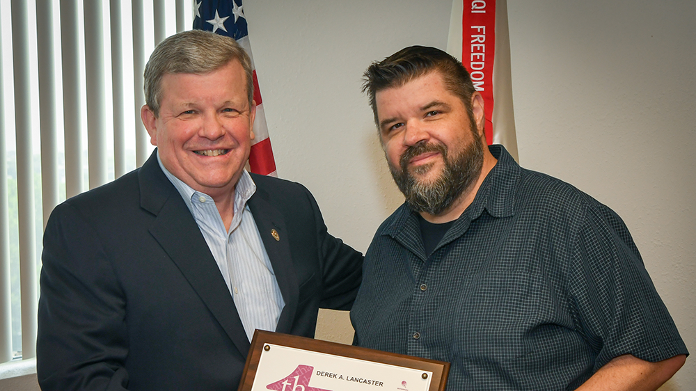 2019_Coin-Award-16 Director/CEO Tom Shull presents awards to Graphic Artist
Derek Lancaster. was presented the new coin from Exchange Director/CEO Tom Shull on July 10.