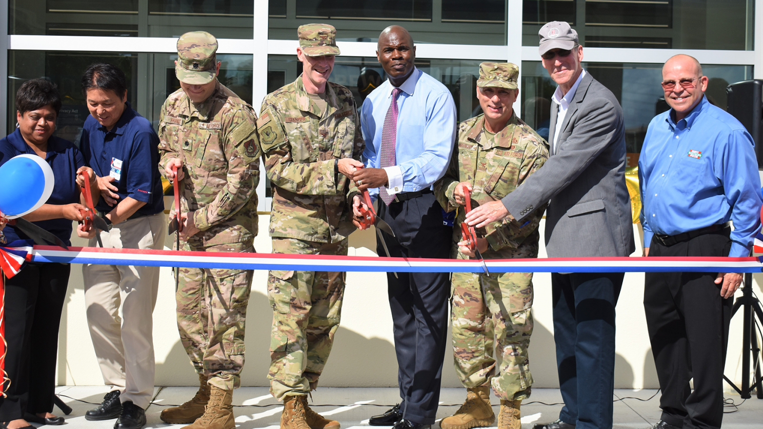 DSC_0335 Pacific Region Commander Col. Scott Maskery and Exchange General Manager Antonio Porter, both center, help cut the ribbon on Kadena AB's new Express.