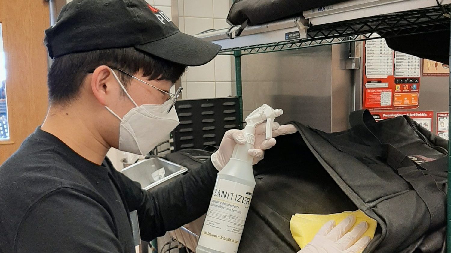 PAC roundup 1 Camp Humphreys Exchange food service worker Han Sang-uk sanitizes a Pizza Hut delivery pouch.