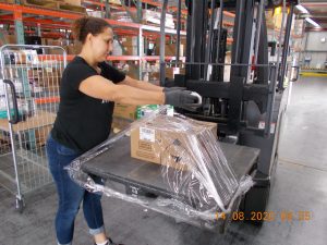Cassandra Kee, a team leader at Army & Air Force Exchange Service Germersheim Distribution Center, prepares shipment of sanitizing and personal protective equipment in Germersheim, Germany, Aug. 14, 2020. (Courtesy photo)