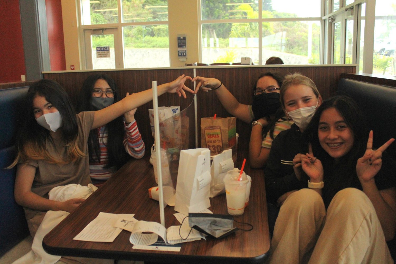 BK 1(1) <strong>On Nov. 23 and 24, Ryukyu Middle-School students pose for a picture after successfully ordered their lunch in Japanese at Kadena Fairchild’s Burger King. Due to the current COVID-19 pandemic, Ryukyu Middle School teachers, Yumi Hasegawa Freeman, Japanese language and Heidi Shimogi, Japanese culture, had to think outside the box to help students find a way to implement their new knowledge and with the help from Kadena Fairchild’s Food Outlet Manager Keita Matsukawa and his Burger King Staff, nearly 180 students ordered their lunch, ate and got back to school in time for their next class. (Photo by Yumi Hasegawa Freeman)</strong>