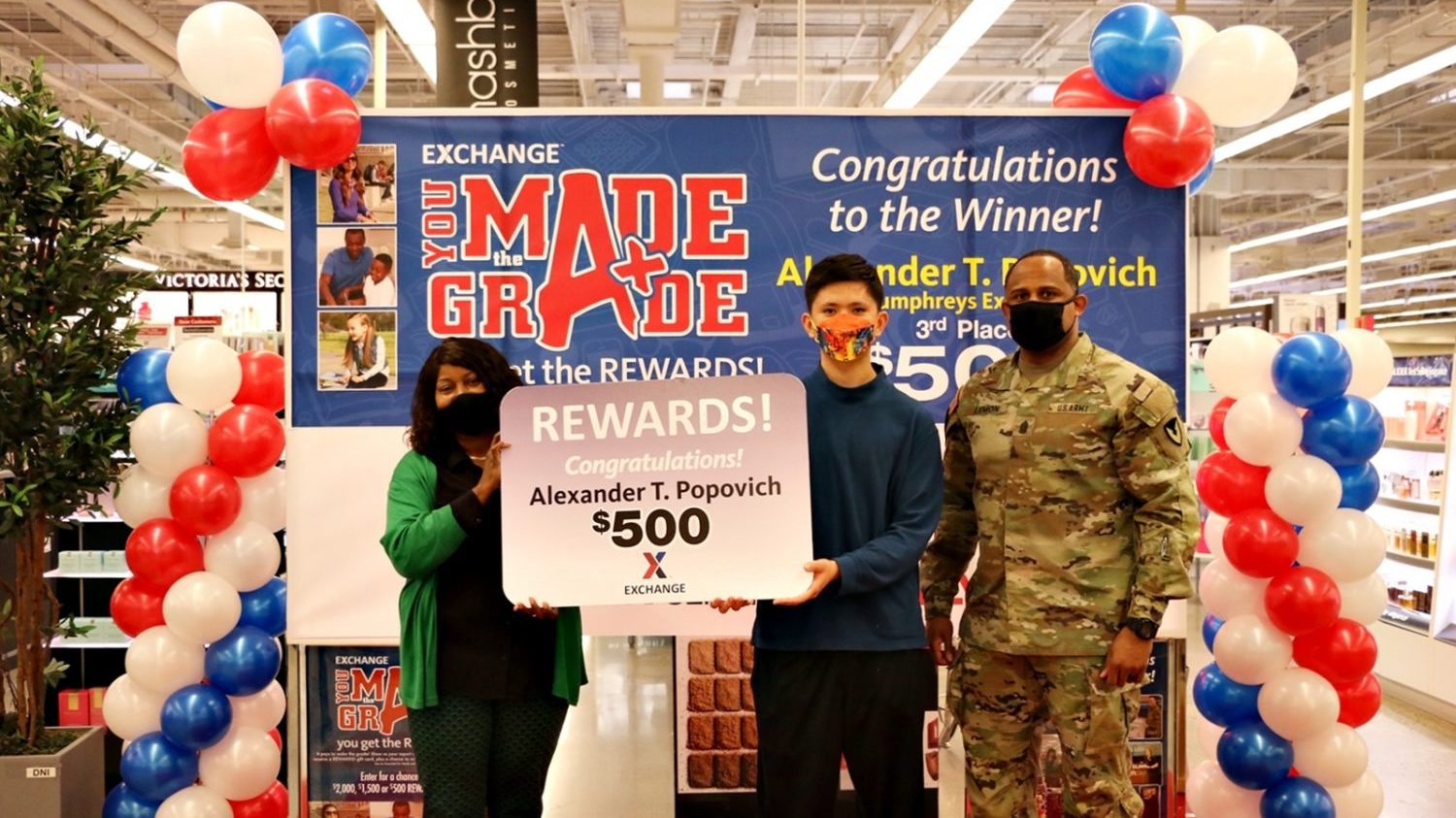 YMTG_Alexander Popovich Humphreys Exchange’s General Manager Vanessa Rowland and United States Army Garrison Command Sgt. Maj. Benjamin Lemon Jr., garrison’s senior enlisted leader, pose for a picture with Alexander Popovich, a 9th grader at Camp Humphreys High School who won $500 for winning 3rd place in the Exchange’s You Made the Grade sweepstakes. The Exchange has been rewarding students with a $5 Exchange gift card for maintaining at least a B average, each quarter, for the past 22 years with a chance to win $2000, $1500 and $500 in a worldwide sweepstakes in December and June. (Exchange Photo by Mun, Yong-chin)