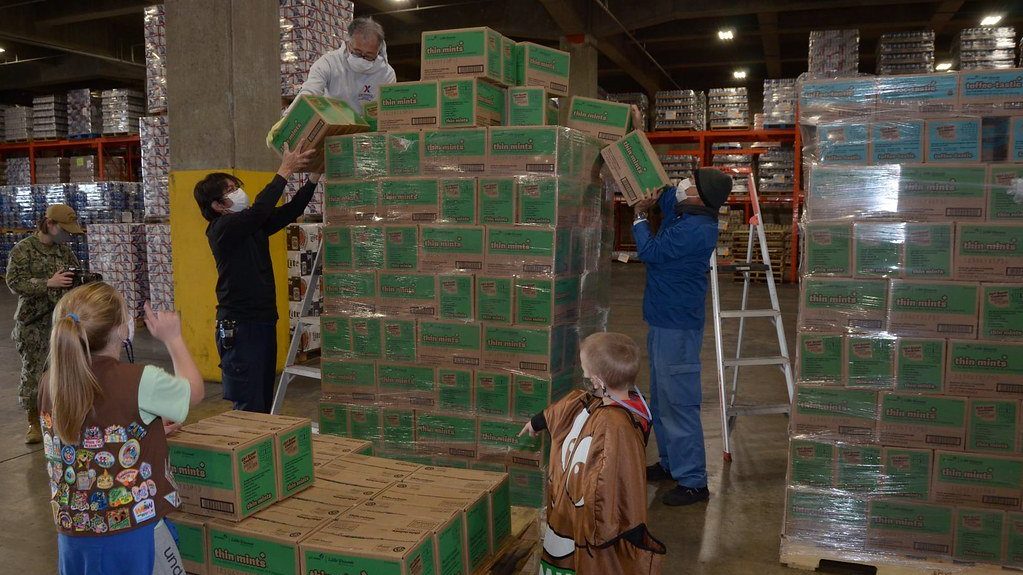 Distribution Center Manager Lewis Meza and his team unload 2,369 boxes of Girl Scout Cookies at Camp Kinser in Okinawa, Japan. For more than 20 years, the Exchange has supported Girl Scout troops by shipping their famous cookies from the U.S. to military installations in the Pacific and Europe Regions, in time for their annual selling season. (U.S. Army Photo by Staff Sgt. Mark A. Kauffman)
