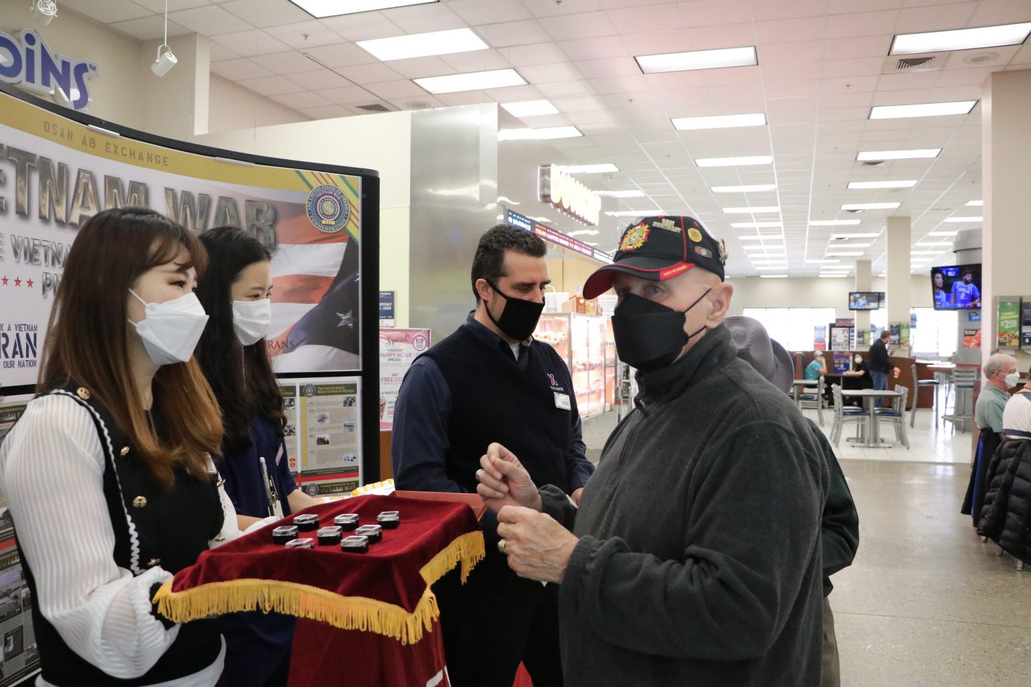 From 2021: From left, Hye-chong Chae, administrative technician; Cha-kyong Kim, store associate; Boris Nasci, general manager; and Ernest Lee, Community Activity chair during National Vietnam War Veterans Day at the Osan Main Store.