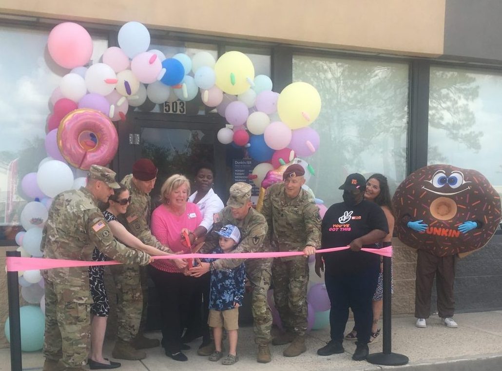 Fort Polk Dunkin-BR <b>Commanding General Brigadier Gen. David Gardner and his wife, Renee, Garrison Commander Col. Stephen Smith, Command Sgt. Maj. Stephen Neilson, Command Sgt. Maj. David Hanson and his wife Christina and son Colt, and Logan Morris of the Greater Vernon Chamber of Commerce helped Exchange leaders cut the ribbon on the new offering. Note the Dunkin' mascot at right.</b>