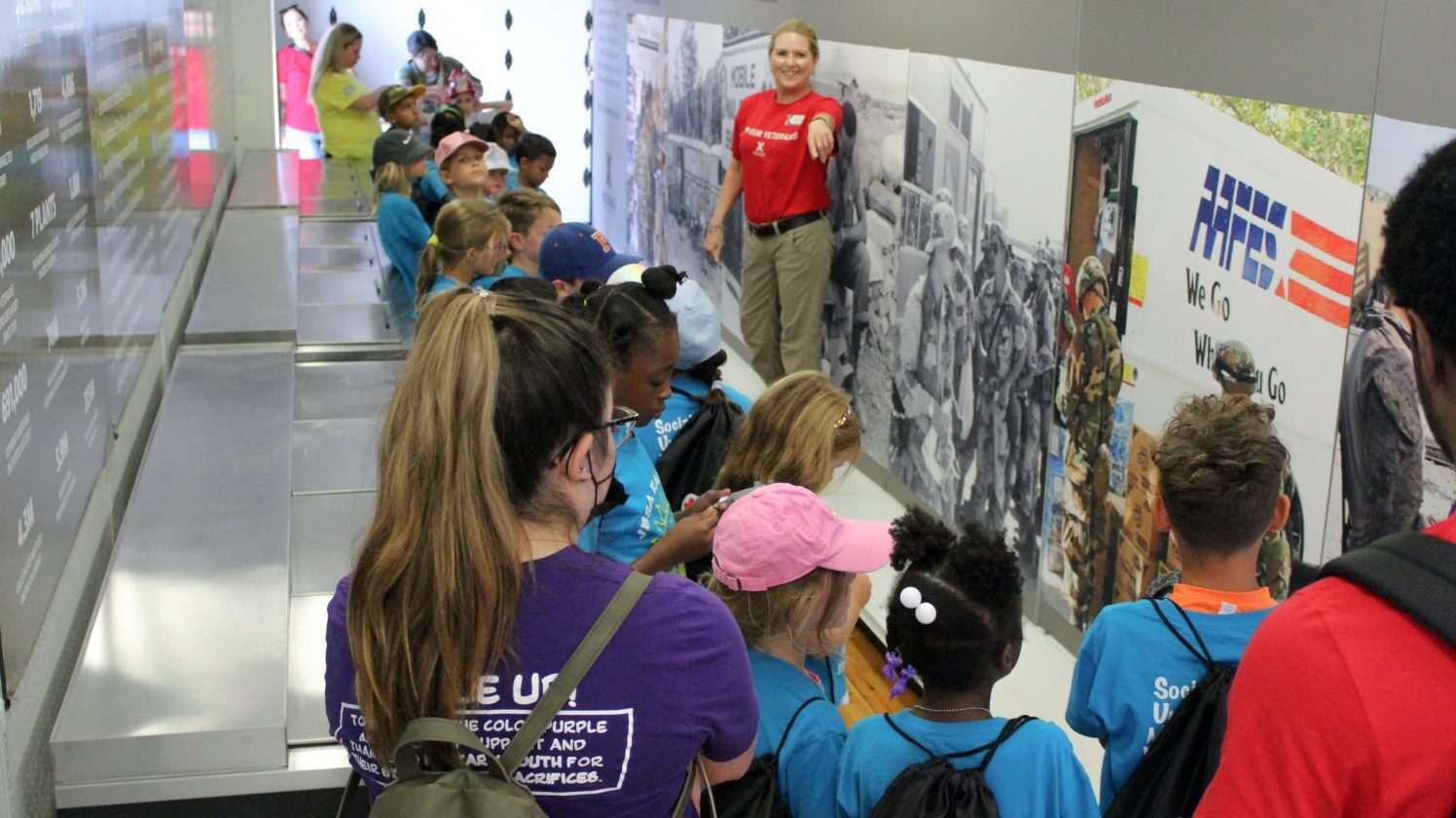 OPJET <b>Lackland Exchange Main Store Manager Patricia Murauskas teaches children about Exchange history during a visit to the Mobile Field Exchange.</b>