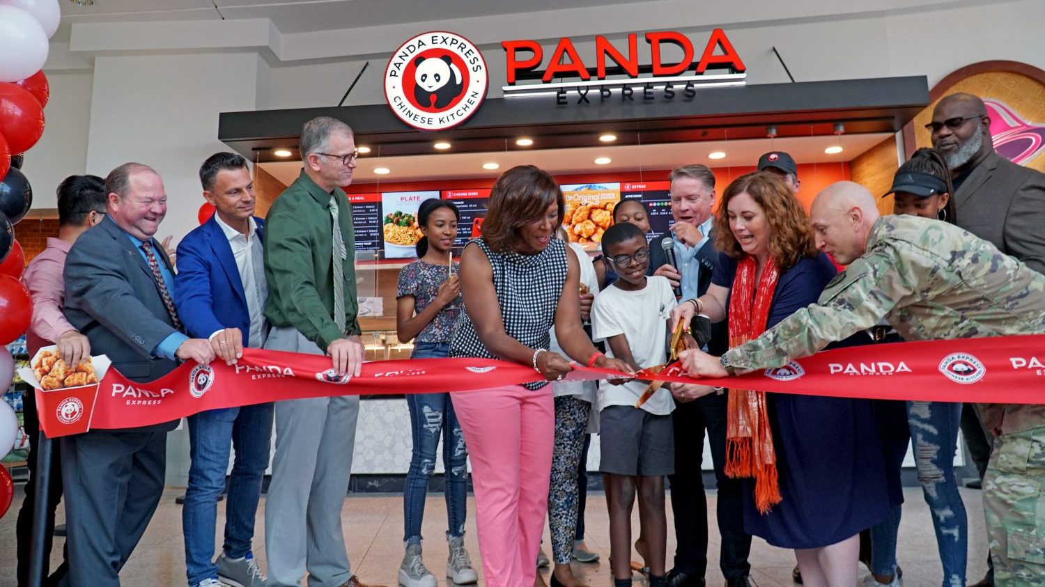 Ramstein_Panda Express_DSC08124 <b>Nataki Jones, wife of Brig. Gen. Otis C. Jones, 86th Airlift Wing commander, along with her 9-year-old son Hamilton, joined Jennifer Jordan, General Manager of the Kaiserslautern Military Community Center Exchange, in cutting the ribbon during the grand opening of first Panda Express to open in Europe Aug. 2, 2022 at Ramstein Air Base, Germany. (From left: Andrew Chan, Panda Express International Director; Bill Williams, KMCC Exchange Service Business Manager; Federico Fanelli, Legardere Travel Retail; Deputy Director John Faulkner, 86th Mission Support Group; Nataki Jones, wife of Brig. Gen. Otis C. Jones, 86th Airlift Wing commander and her son Hamilton; Jennifer Jordan, KMCC Exchange General Manager; Col. Don Nowlin, Exchange Europe/Southwest Asia/Africa Region commander) </b>
