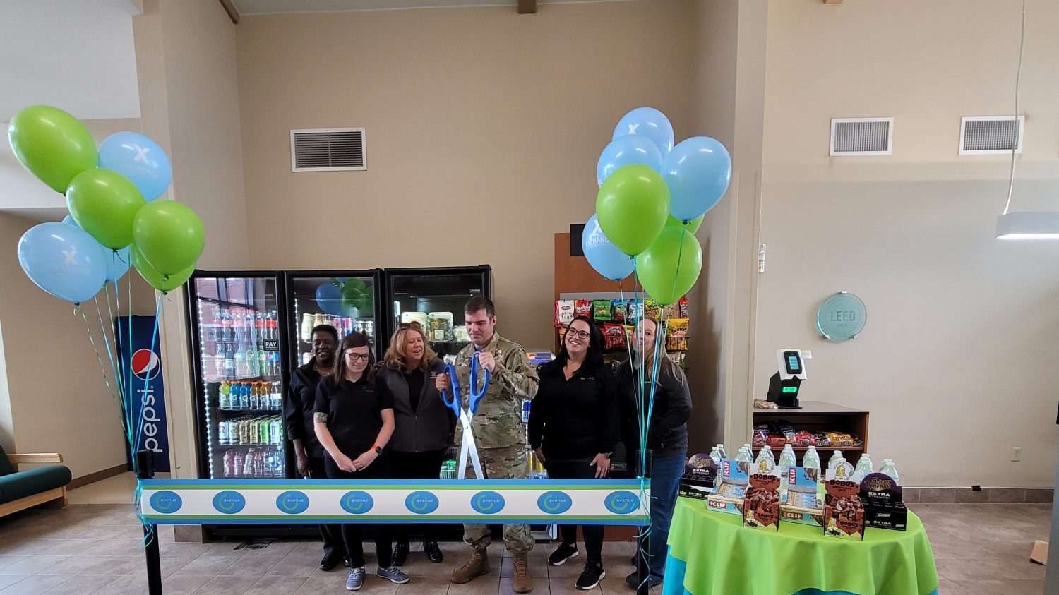 <b>From left, Terri Hill, Services Business Manager; Julia Reynolds Services Operations Assistant;
Dawn Williams, outgoing Services Business Manager; 
SFC Ates, Building Noncommissioned Officer in Charge; 
and Julianne Yuhas,  Ave C Manager, cut the ribbon on the micro market.</b>
Crystal Stebbins Ave C / Canteen General Manager
