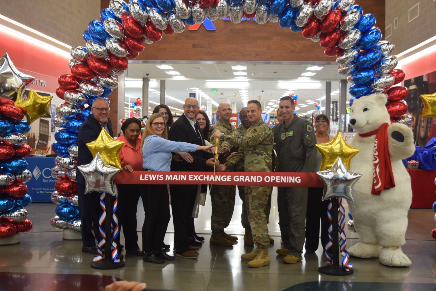 JBLM GO <b>From left, Exchange Western Region Senior Vice President Ronny Rexrode, JBLM Lewis Exchange Food Business Manager Patricia Beavers, JBLM Lewis Exchange Main Store Manager Stacie Sterling, JBLM Exchange General Manager Matthew Beatty, Command Sgt. Maj. Waylon Perry, Col. Christopher Hall, Garrison Commander Col. Phil Lamb, Vice Wing Commander Col. David J. Morales; in back, Food Business Manager Kathleen Phelps, Exchange Northwest Area Regional Vice President Carrie Cammel, Chief Master Sgt. John Marquez and JBLM Lewis Exchange Retail Business Manager Penny Palmer cut the ribbon on the Joint Base Lewis-McChord Lewis Main Exchange’s $72.6 million renovation Sept. 28. Photo by JBLM Lewis Exchange Sales and Merchandise Manager Jocelyn Rosario.