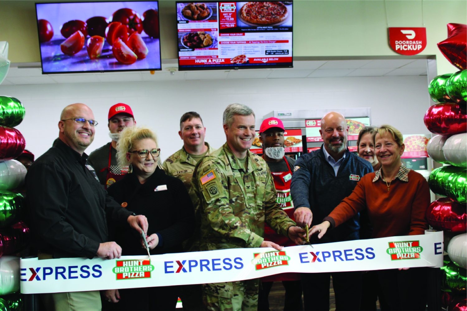 HBP Ft Sill Ribbon Cutting <B>Front row, from left: Fort Sill Exchange General Manager Mikel Hunter, Facility Manager Angela McCracken, Garrison Commander Col. James Peay, Hunt Brothers Pizza representative Steven Church and Garrison Deputy Commander Ms. Julia Sibilla. Back row, from left: Associate Joseph Claflin, Command Sgt. Maj. William, Associate Dante McCowan and Assistant Store Manager Bonnie Hines.