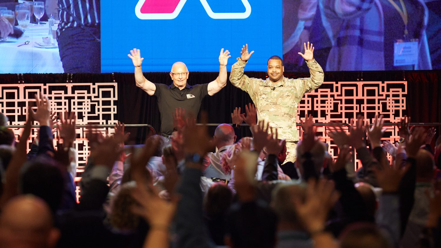 MicrosoftTeams-image (70) <b>Before his "Chief Chat" with Exchange Senior Enlisted Advisor Chief Master Sgt. Kevin Osby (right), celebrity chef Robert Irvine encouraged the audience to wave their hands in the air and scream.</b>