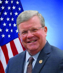 Head shot of Exchange Director/CEO Tom Shull, with American flag