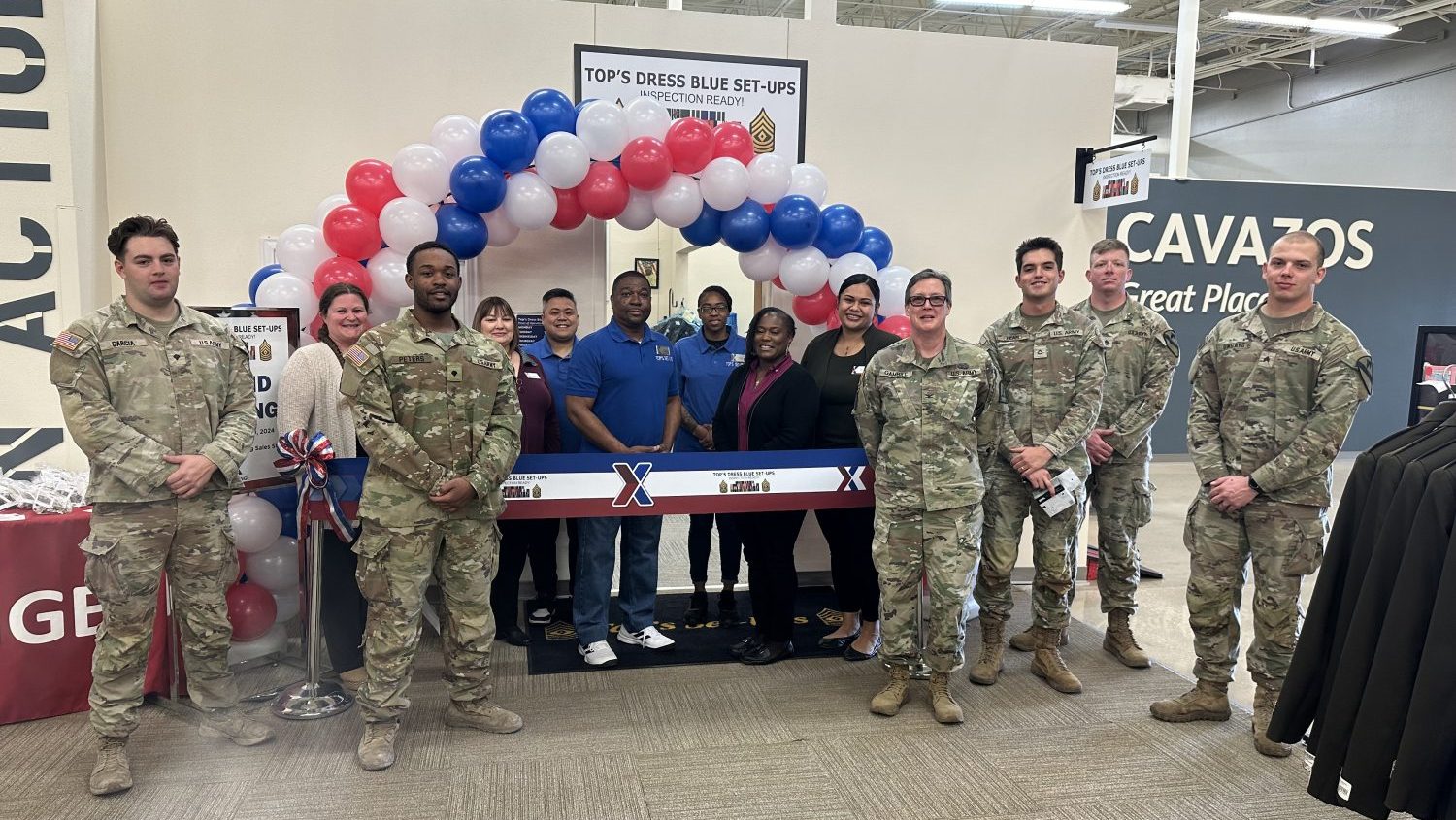 From left: Specialist Garcia; Exchange Services Business Technician Crystal Vowell; Specialist Peters; Exchange Services Business Manager Pamela Hunter; Tops Employee Aljay Ambuyoc; Tops Owner and Army Veteran Mark Draper; Tops Employee Veronica Stroy; General Manager CJ Morganfield; Assistant Services Business Manager Lita Patu; Col. Gambill; Specialist Bean; and Staff Sgt. Ungard.