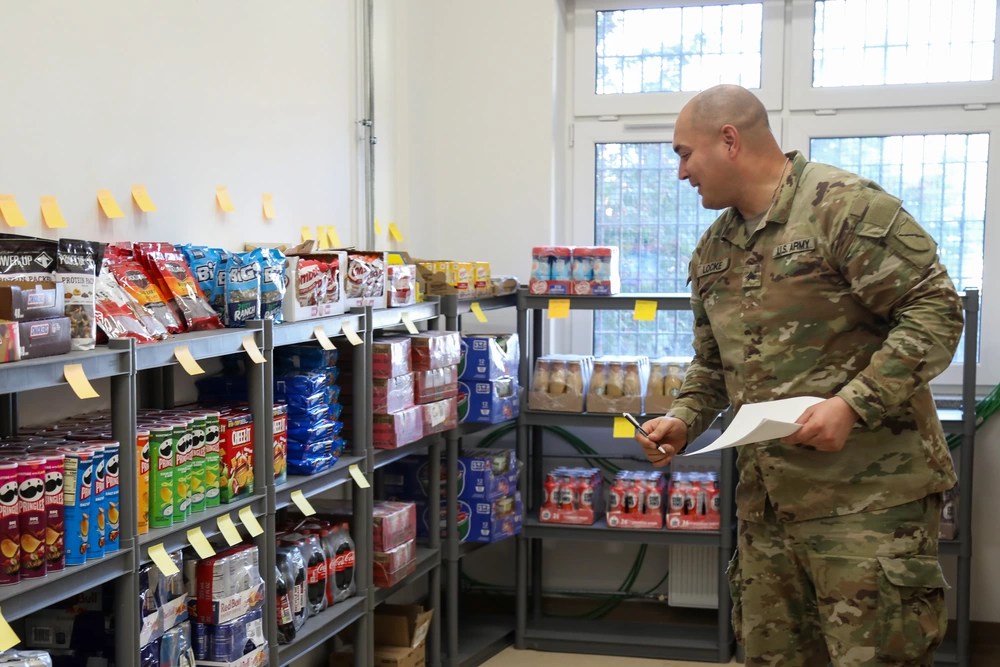 >b>U.S. Army National Guard Sgt. Justin Locke, a motor transport operator assigned to 2113th Transportation Company from Paducah, Kentucky, and deployed to Świętoszów, prepares for the opening of an Army Air Force Exchange Store at the unit's Forward Operating Site in Poland, Feb. 26, 2024. Task Force Provider, as part of a rotation of forces in Europe, is working to set the V Corps area of operations for sustainment and improve quality of life facilities for Soldiers stationed there. The 3rd Infantry Division deployed to Europe to engage in multinational training and operations to build readiness for contingency response and deter adversaries. (U.S. Army photo by  Sgt. 1st Class Jason Hull)