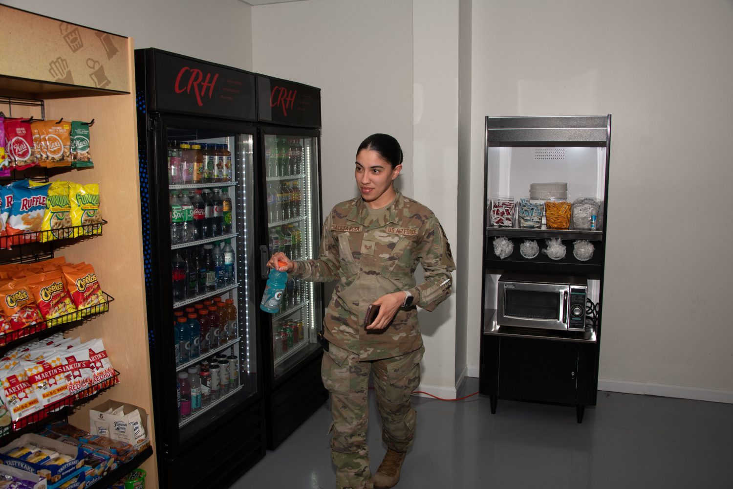 53680276936_cd916be8a9_k <b>.S. Air Force Senior Airman Kendra A. Alicea Rosa grabs a drink from the new 24/7 unattended retail unit at Joint Base Andrews, Md., April 25, 2024. The new unattended retail unit was opened to provide over 900 security forces personnel on base round-the-clock food options. (U.S. Air Force photo by Senior Airman Daekwon Stith)</b>
