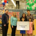 Brayden Snow accepts third place in the Exchange's You Made the Grade contest, accompanied by his parents and sister. Also pictured are the USAG Humphreys Exchange general manager and store manager.