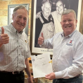 Exchange Director/CEO Tom Shull and Bass Pro Shops founder and noted conservationist Johnny Morris display the agreement to bring Bass Pro Shops to the Exchange