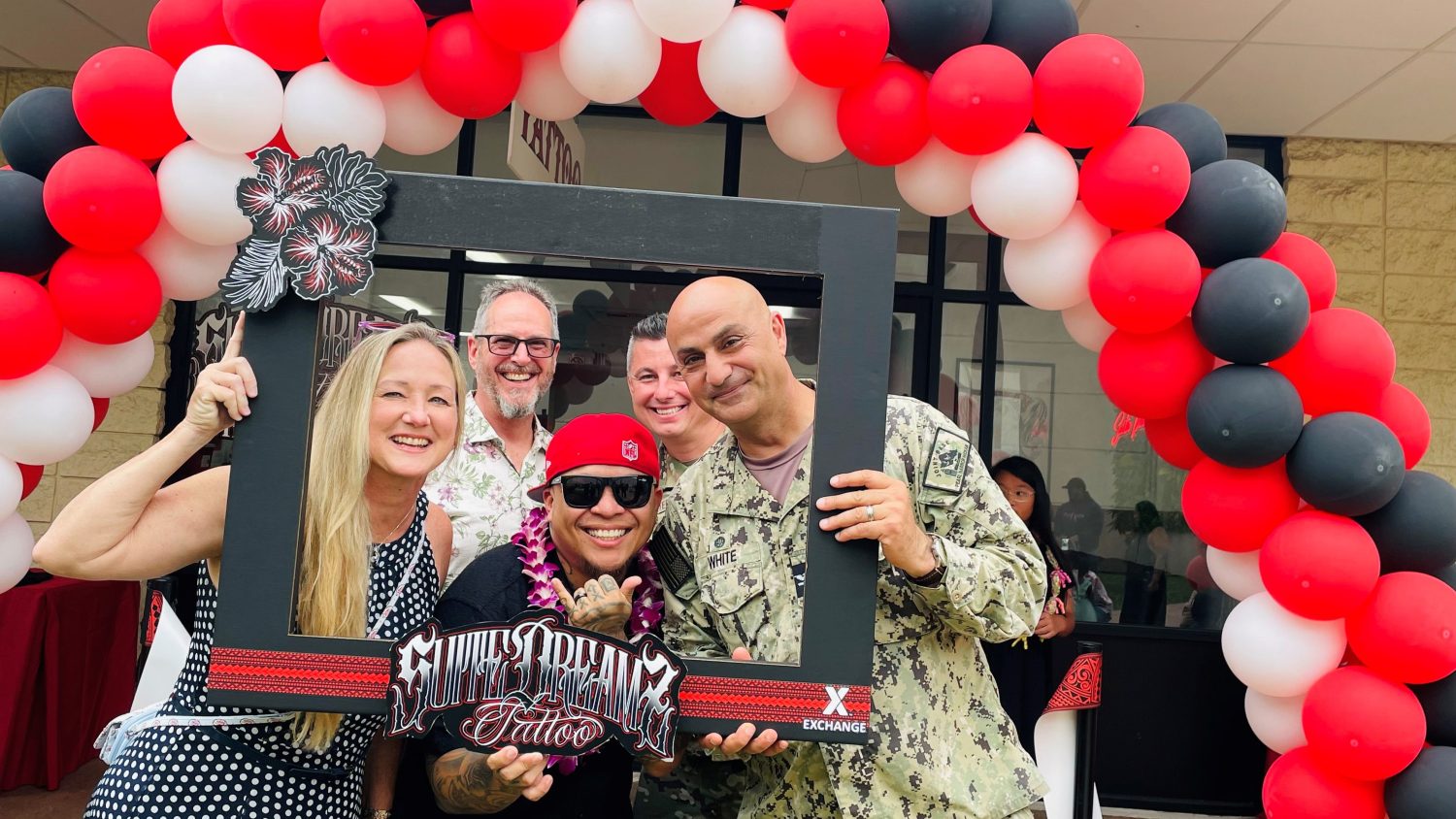 JBPHH_Suite Dreamz_Ms. White, Executive Director Scott Thompson, Owner Neil Porras, CAPT White <b>From left: Robin White, wife of Joint Base Pearl Harbor Hickam Capt. Sam "Smokey White; JBPHH Executive Director Scott Thompson; Neil Porras, owner, Suite Dreamz Tattoo Studio; JBPHH Commander Capt. Sam "Smokey" White. Suite Dreamz, which held its grand opening March 17 at Hickam AFB, is the first Exchange tattoo studio in Pacific Region.</b>
