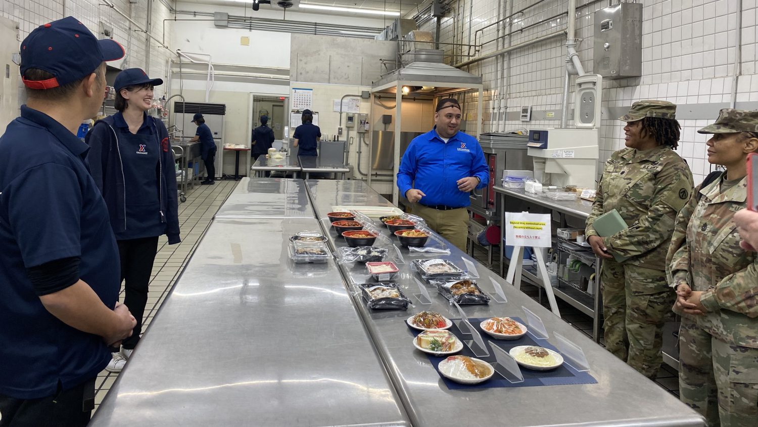 <b>Yokota Exchange General Manager Andrew Defelice, center, talks to Yokohama North Dock Commander Xx and CMS XX as XX look on.
