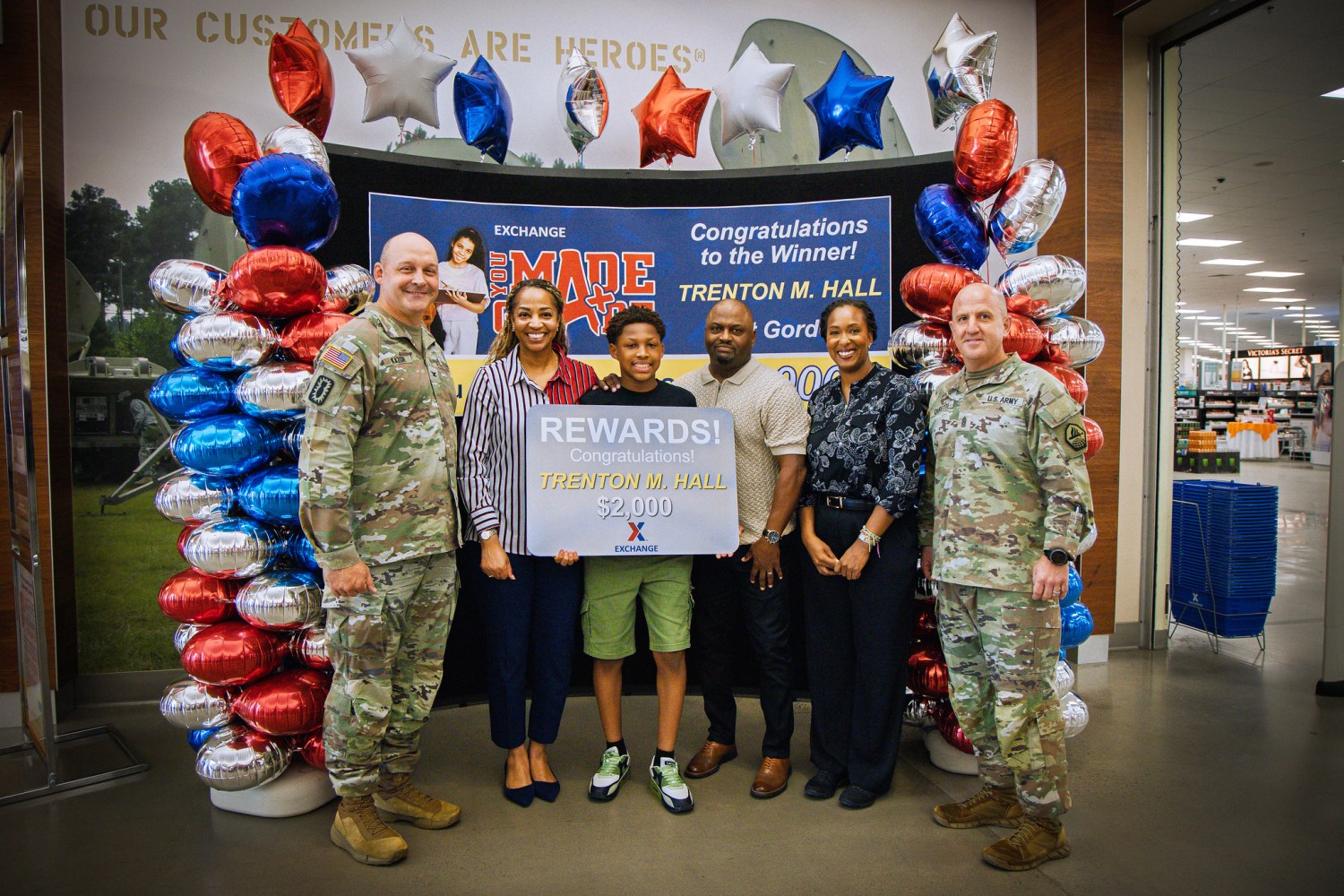 <b>FORT GORDON, Ga. – Col. Anthony Kazor, Fort Gordon garrison commander, and Latoya Harris, Fort Gordon Exchange general manager, present a $2,000 gift card to Trenton Hall at the Fort Gordon Main Exchange, Aug. 12, 2025. Hall, a ninth grader at Augusta Christian School, was the worldwide first-place winner in the Army & Air Force Exchange Service’s "You Made the Grade" sweepstakes, which recognizes academic excellence among military-connected students. He was selected from more than 2,300 entrants after maintaining at least a B average during the spring semester. The son of retired Army veterans, Hall enjoys studying science, plays soccer, and has aspirations of becoming a professional soccer player. The Exchange, a Department of Defense retailer since 1895, supports military quality-of-life programs and provides goods and services to Soldiers, Airmen, Guardians, and their families worldwide. (U.S. Army photos by David Logsdon)</b>