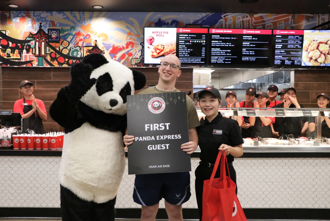 Osan Panda_First Guest <b>Senior Airman Daniel Madden, 51st Communications Squadron, arrived at 6 a.m. to be first in line for the grand opening of Panda Express at the Osan Ezchange. Madden, shown with Osan Panda Express Store Manager Sabrina Seol, worked at a Panda Express in Murfreesboro, Kentucky, before enlisting in the Air Force.</b>