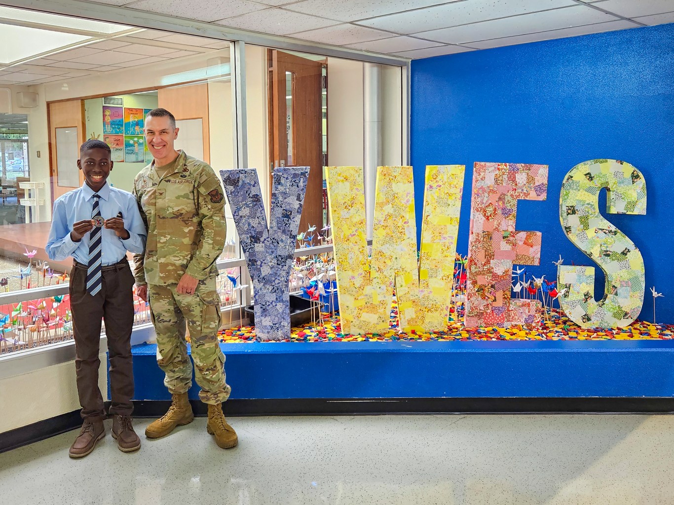 Fifth grader Nii Borketey and Exchange Pacific Region Commander Col. Jason Beck in hallway at Yokota West Elementary School.