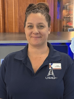 Photo of Anna Geraneo wearing shirt with Space Force logo, along with Exchange badge.