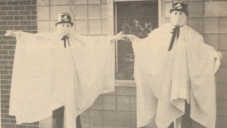 Two men dressed as ghosts.