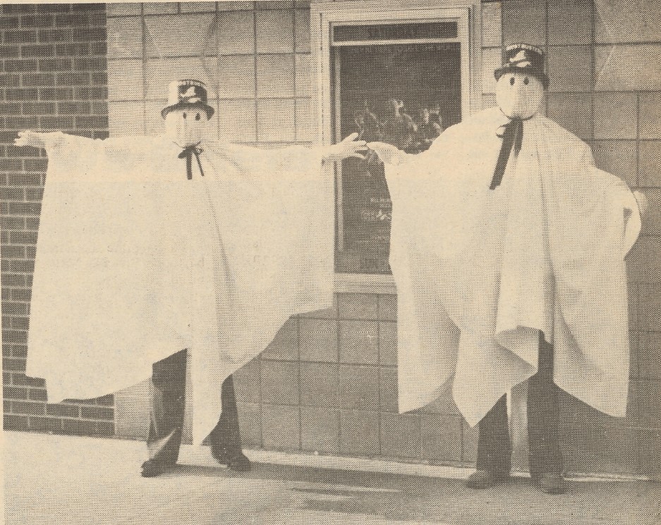 Two men dressed as ghosts.