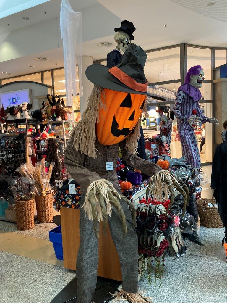 Scarecrow with Jack-o-Lantern head in Kaiserslautern Military Community Exchange mall.
