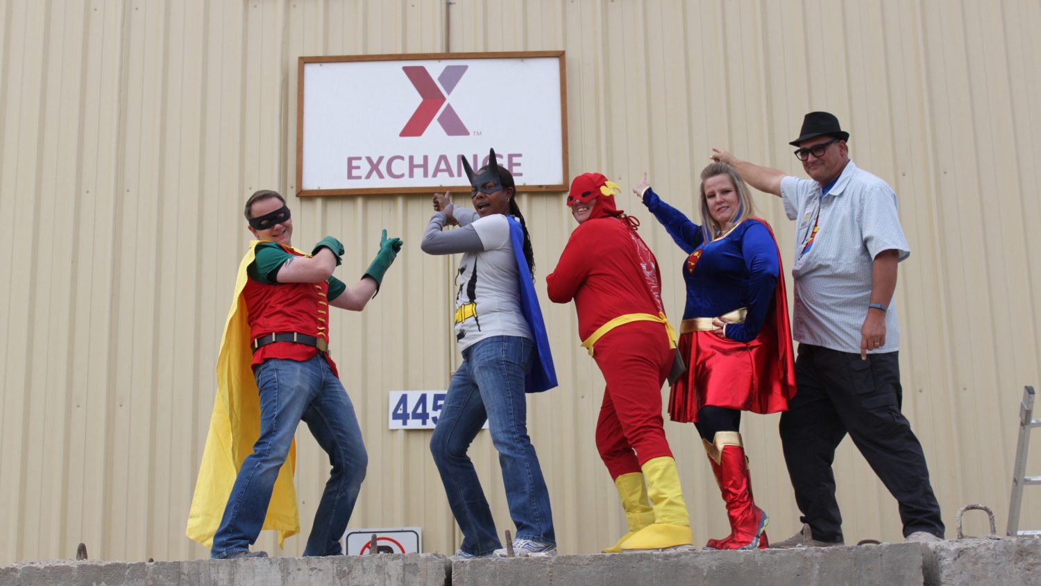 2014 photo of five Bagram AB associates in Halloween costumes pointing at Exchange sign.