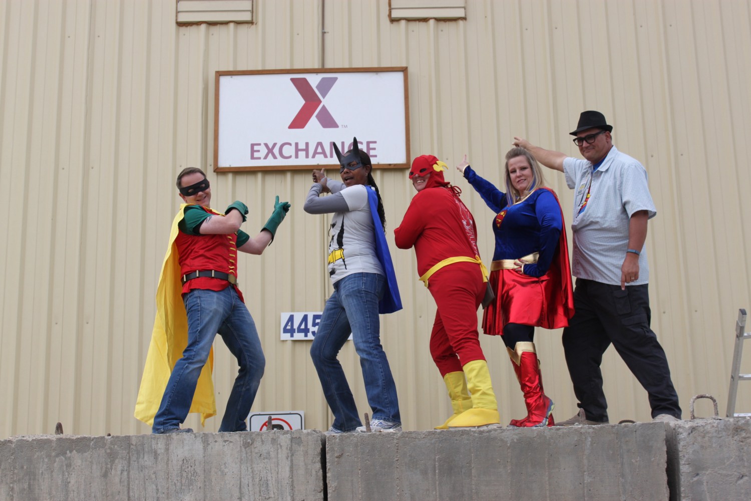 2014 photo of five Bagram AB associates in Halloween costumes pointing at Exchange sign.