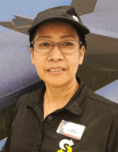 Virna Narita wearing Exchange badge, and cap and shirt with Subway logo.