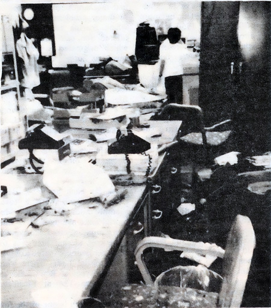 Interior damage, with papers and furniture scattered.